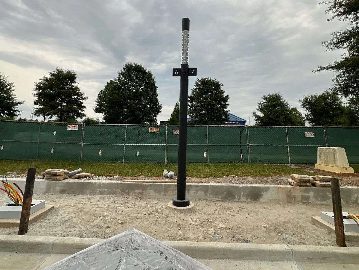 Precast pole base set to grade in Locust Grove, Georgia, before pavers were installed
